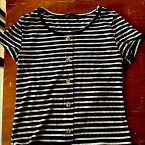 This is a shirt to wear anywhere. It’s has black and white stripes with buttons.